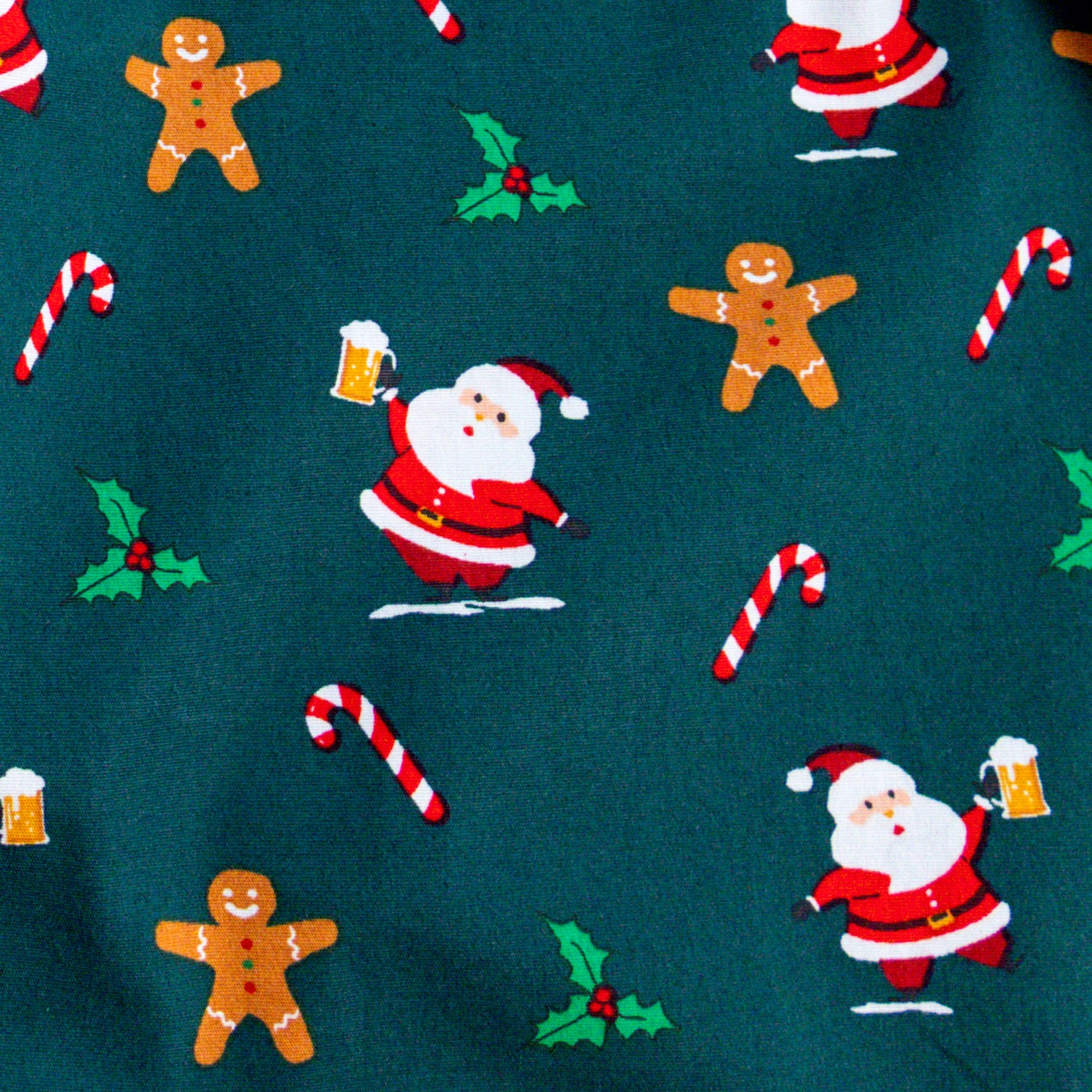 Christmas-themed fabric pattern with Santa Claus, gingerbread men, and candy canes on a teal background.