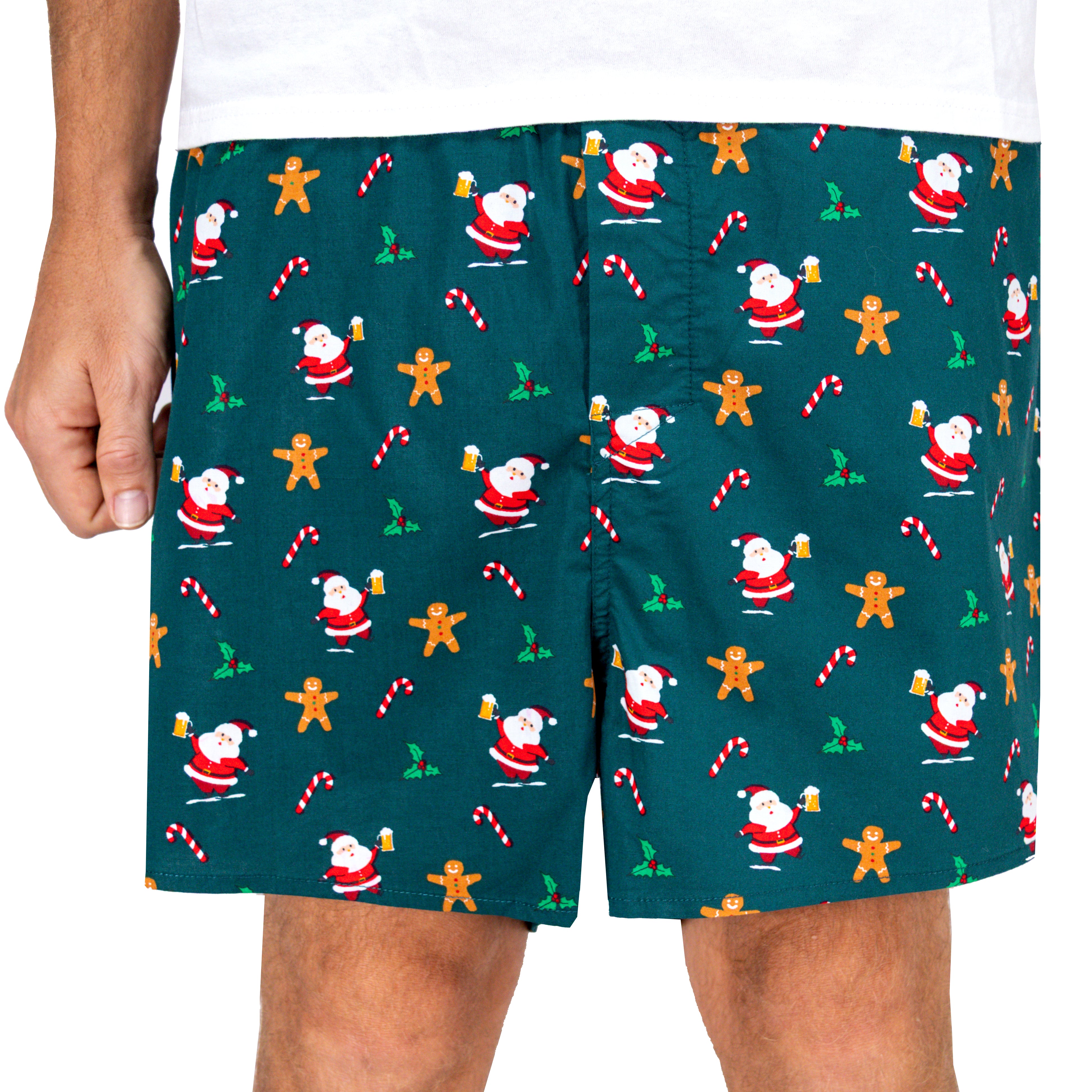 Christmas-themed shorts with Santa Claus, gingerbread men, and candy canes on a green background.