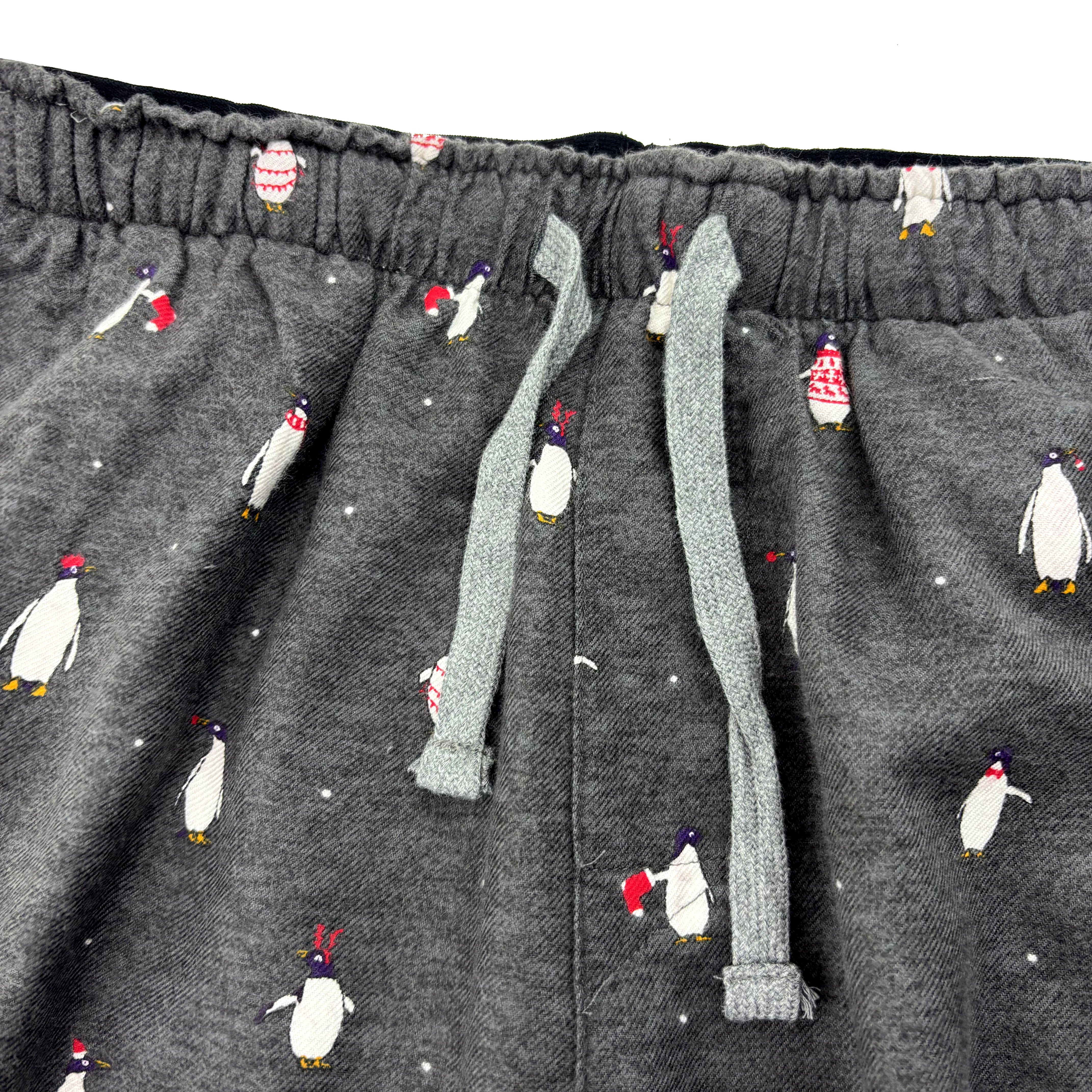 Dark gray pants with penguin pattern on a white background