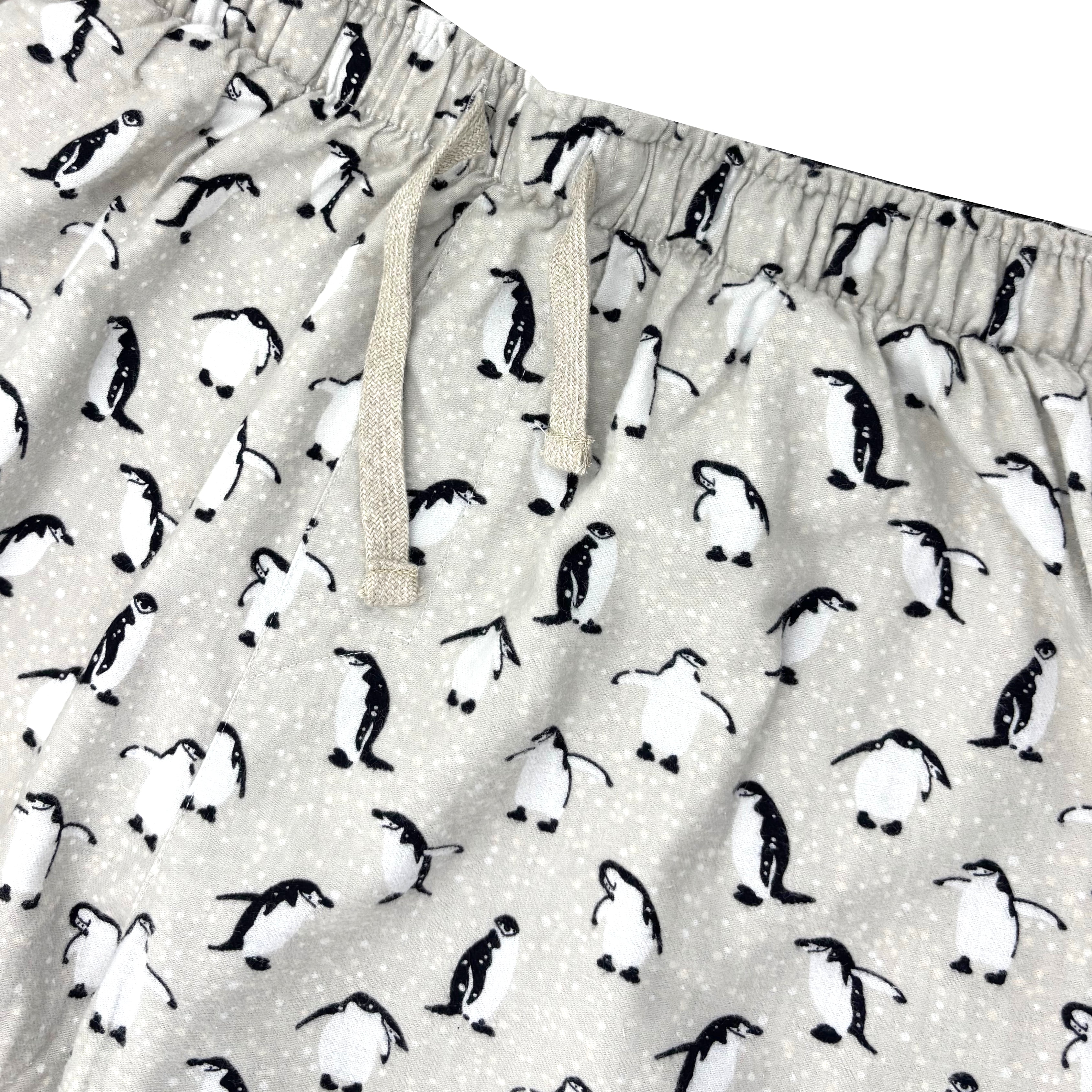 Pajama shorts with penguin pattern on a light gray background