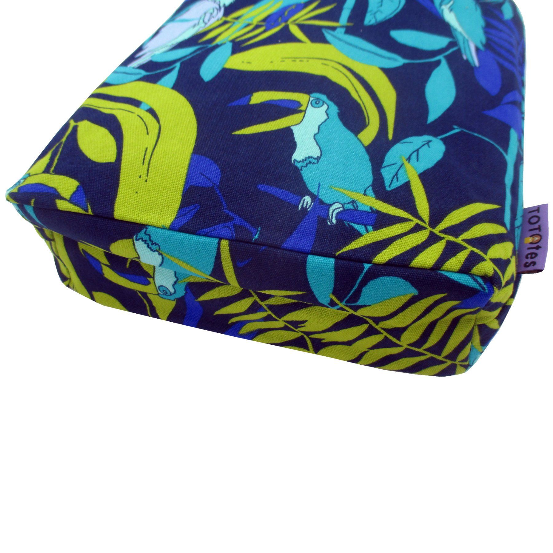 This jungle inspired bag features a blue green print made up of parrots and toucans against tropical leaves in the background.